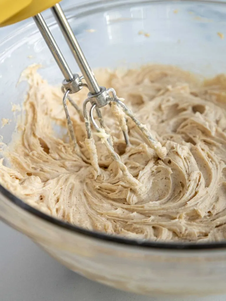 image of cinnamon buttercream being mixed together with a hand mixer