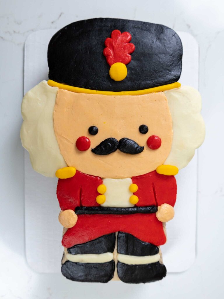 image of a cute nutcracker cake frosted with homemade buttercream frosting