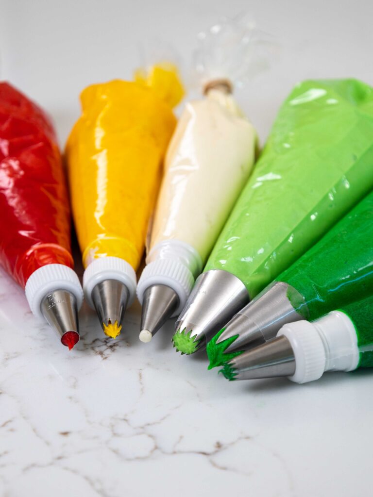 image of buttercream frosting that's been colored with gel food coloring and placed in piping bags