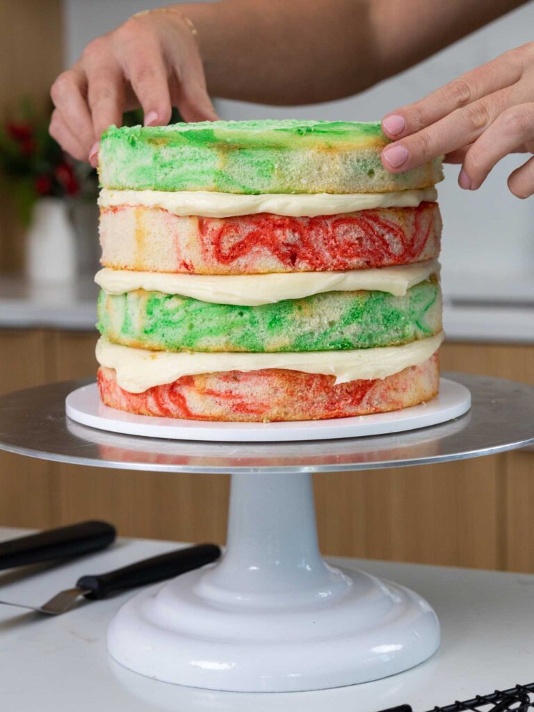 image of green and red marbled cake layers that have been stacked and frosted with buttercream