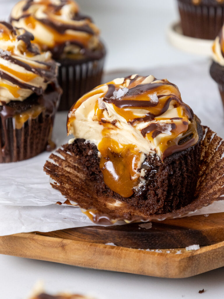 image of a caramel filled chocolate cupcake that has been cut open to show its filling