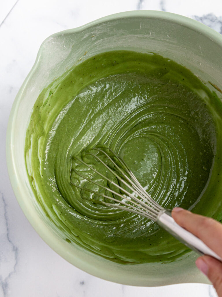 image of matcha cupcake batter being mixed together with a whisk