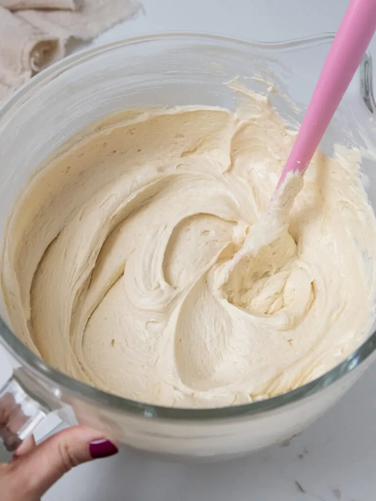 image of brown sugar buttercream that's been mixed in a glass kitchen aid bowl
