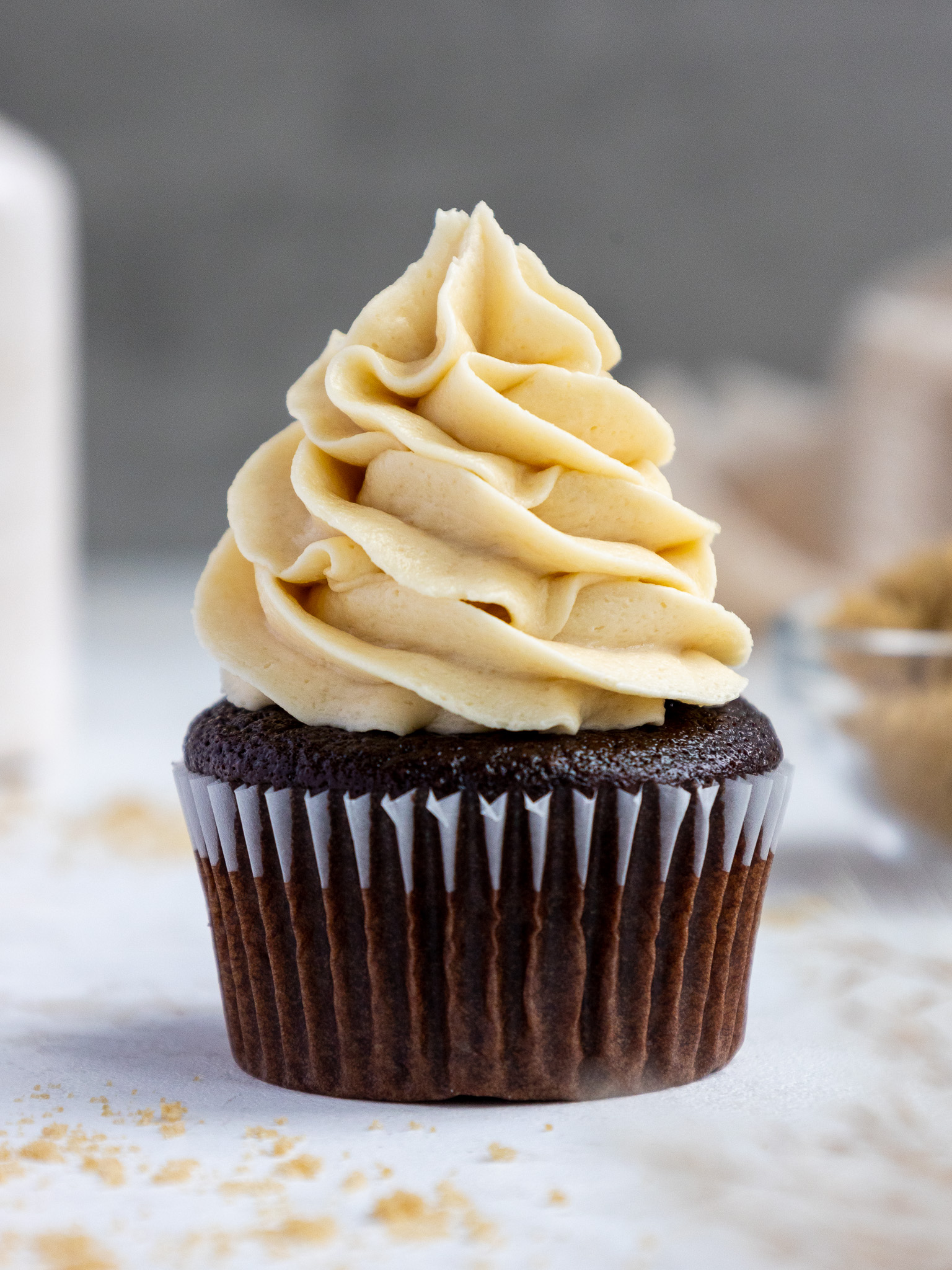 image of brown sugar frosting that's been piped onto a chocolate cupcake
