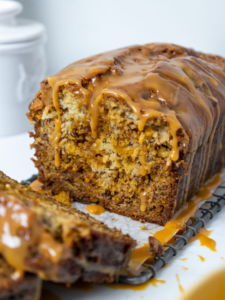 image of a loaf of butterscotch banana bread that's been cut into to show how tender and moist it is