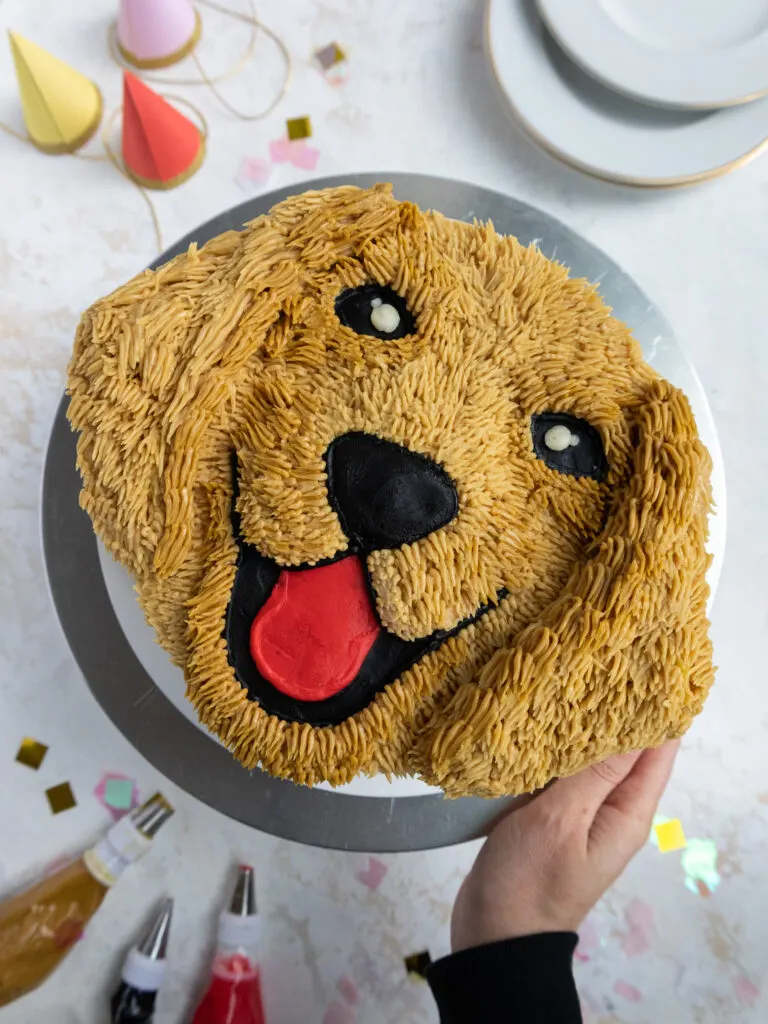 image of a golden retriever puppy cake that's been decorated with buttercream frosting