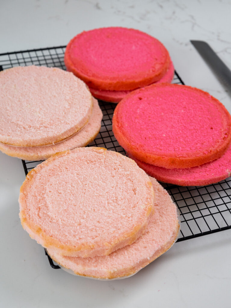 light and dark pink velvet cake layers that have been trimmed and torted with a serrated knife
