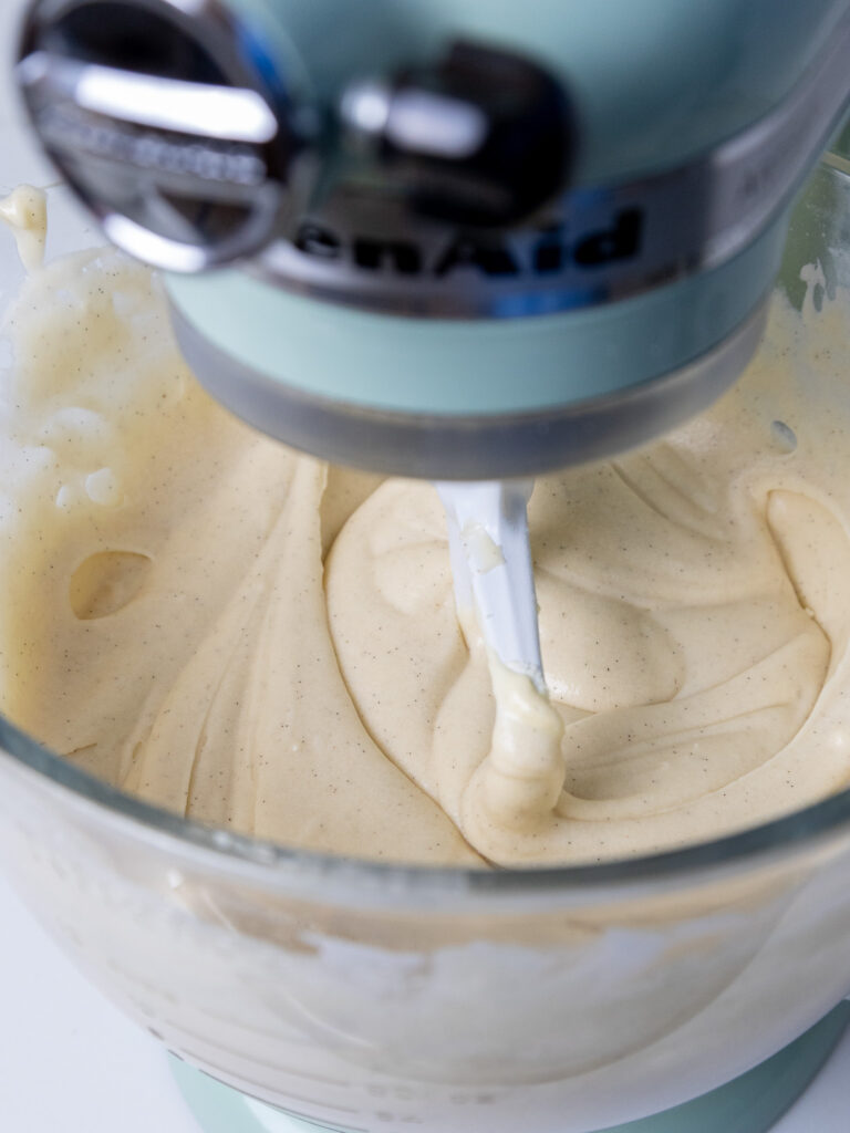 image of vanilla bean cake batter being mixed in a KitchenAid mixer