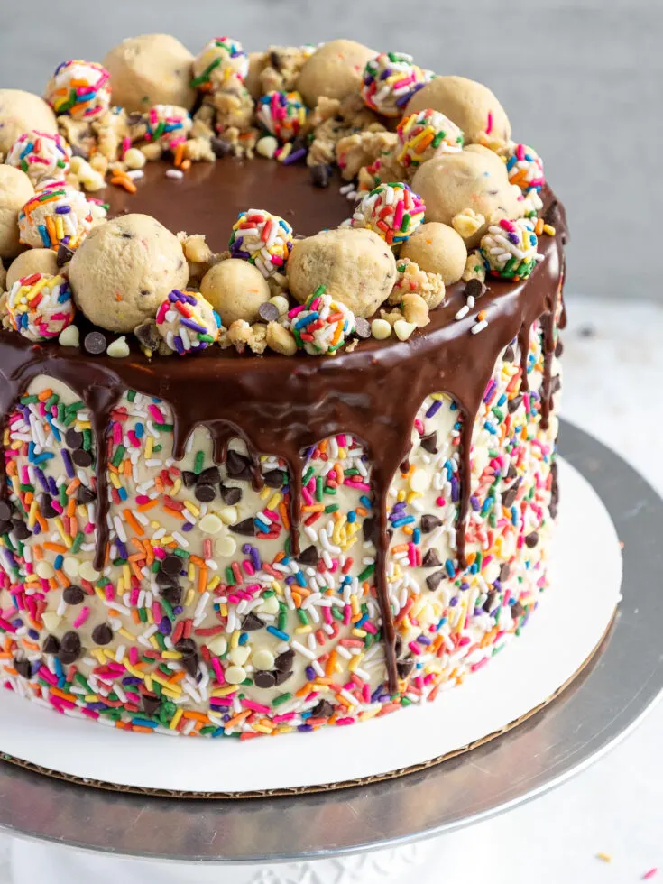 image of a cookie dough cake that's been decorated with edible cookie dough and sprinkles
