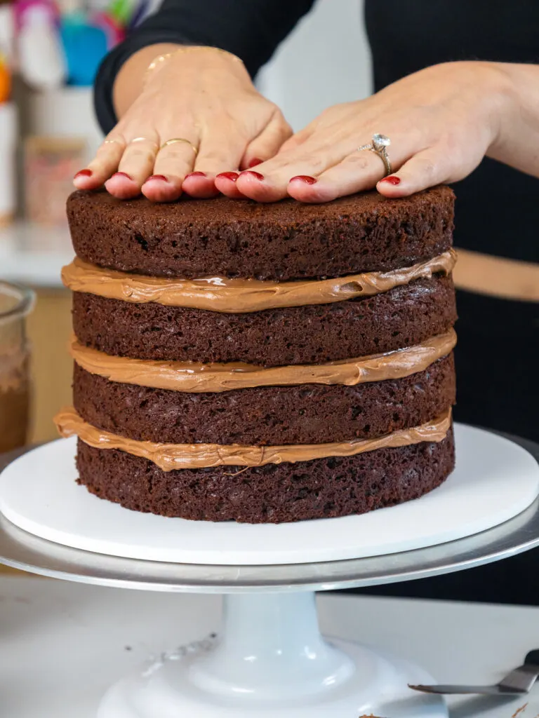 image of chocolate cake layers being stacked to make a Nutella chocolate cake