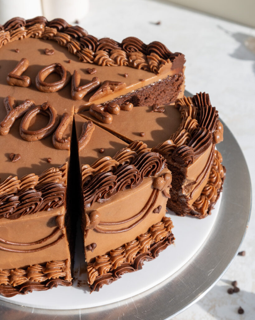 image of a chocolate heart shaped lambeth cake that's been cut into