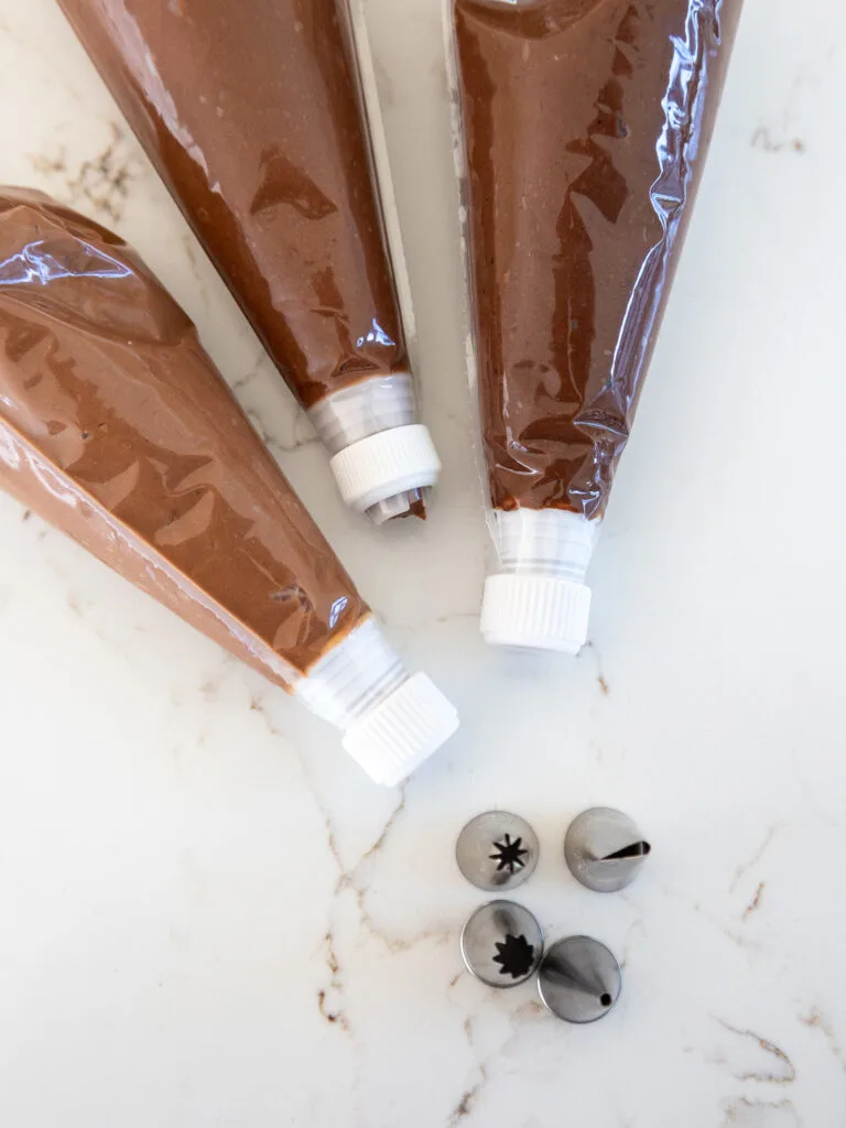 image of chocolate buttercream in piping bags fit with couplers