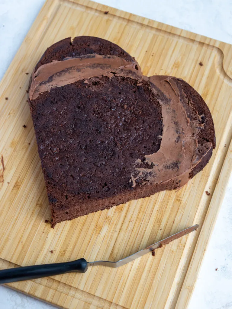 image of a round cake layer that's been trimmed and turned into a heart shaped cake layer