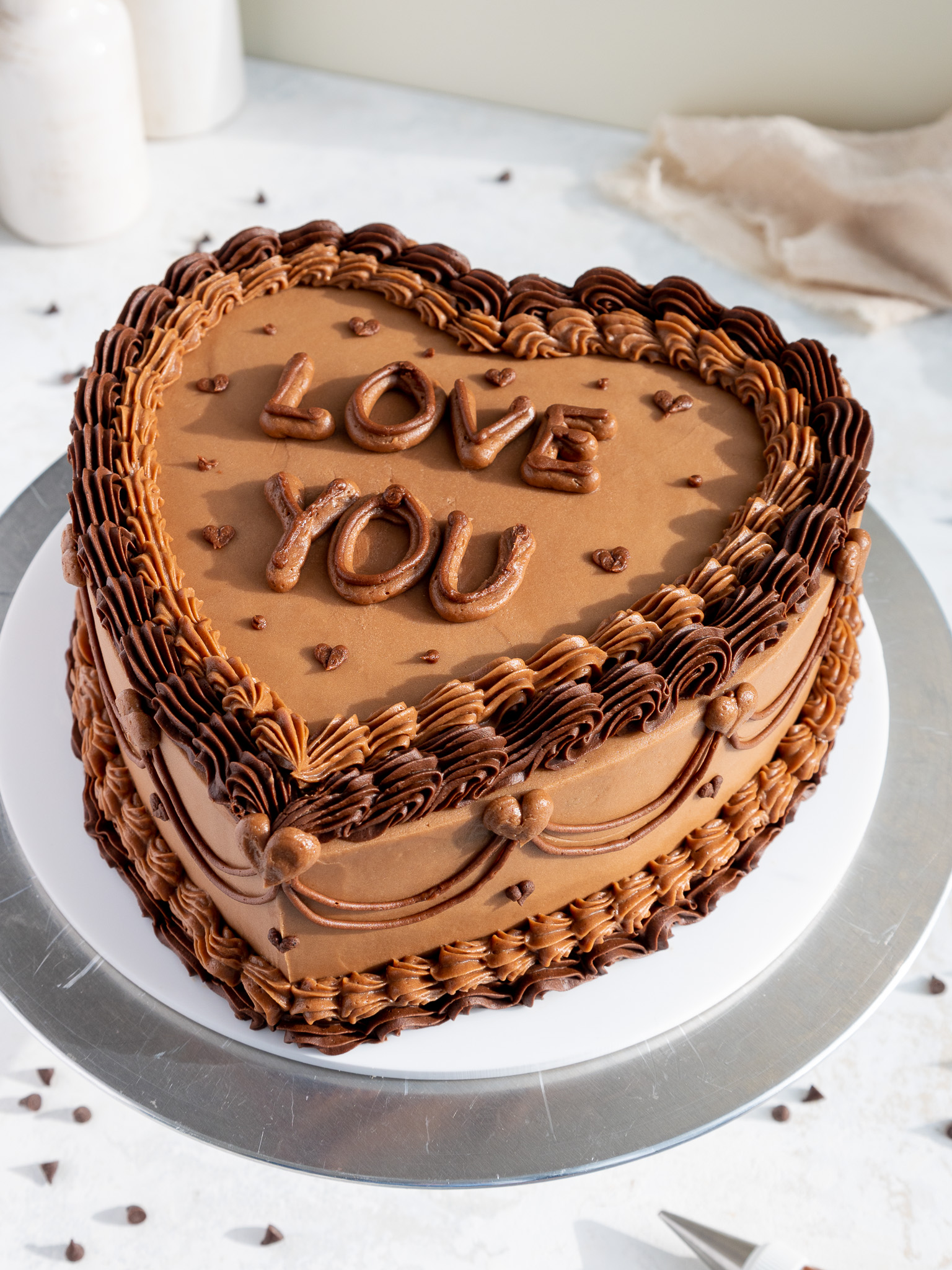 image of a heart shaped chocolate cake that's been decorated with chocolate buttercream in the lambeth style
