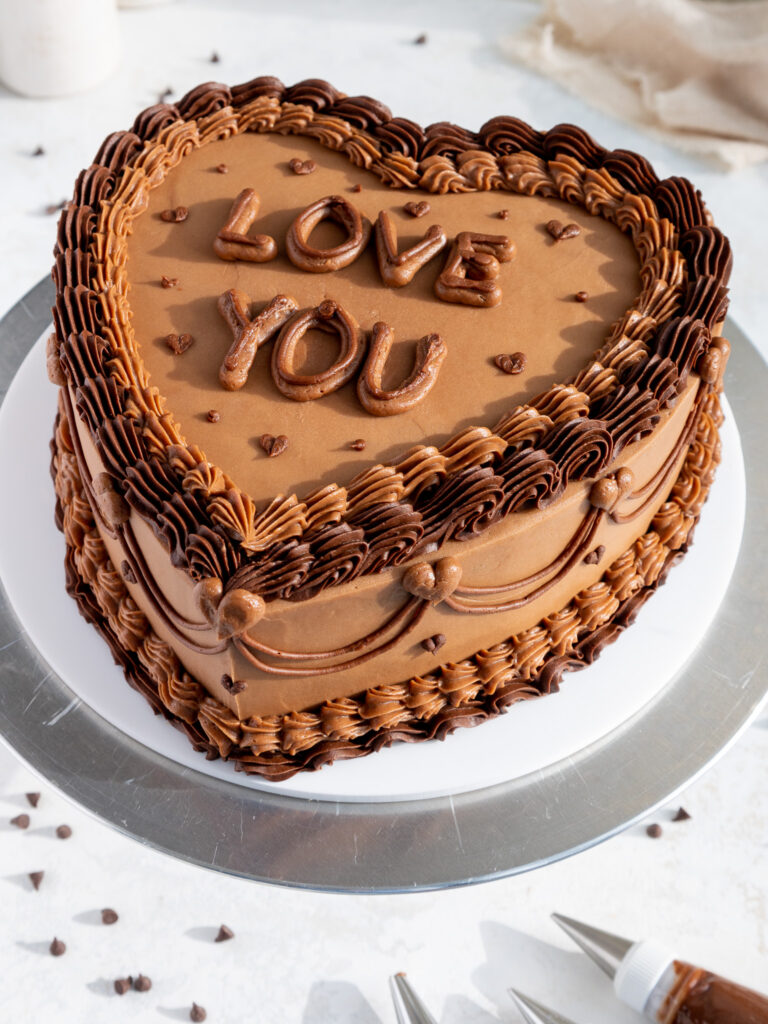 image of a heart shaped chocolate cake that's been frosting with chocolate buttercream frosting
