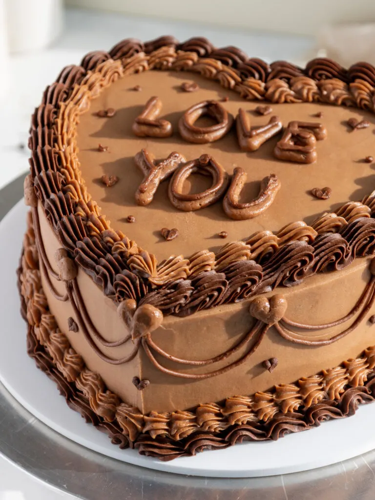 image of a chocolate lambeth cake that's been decorated with chocolate buttercream frosting for valentine's day