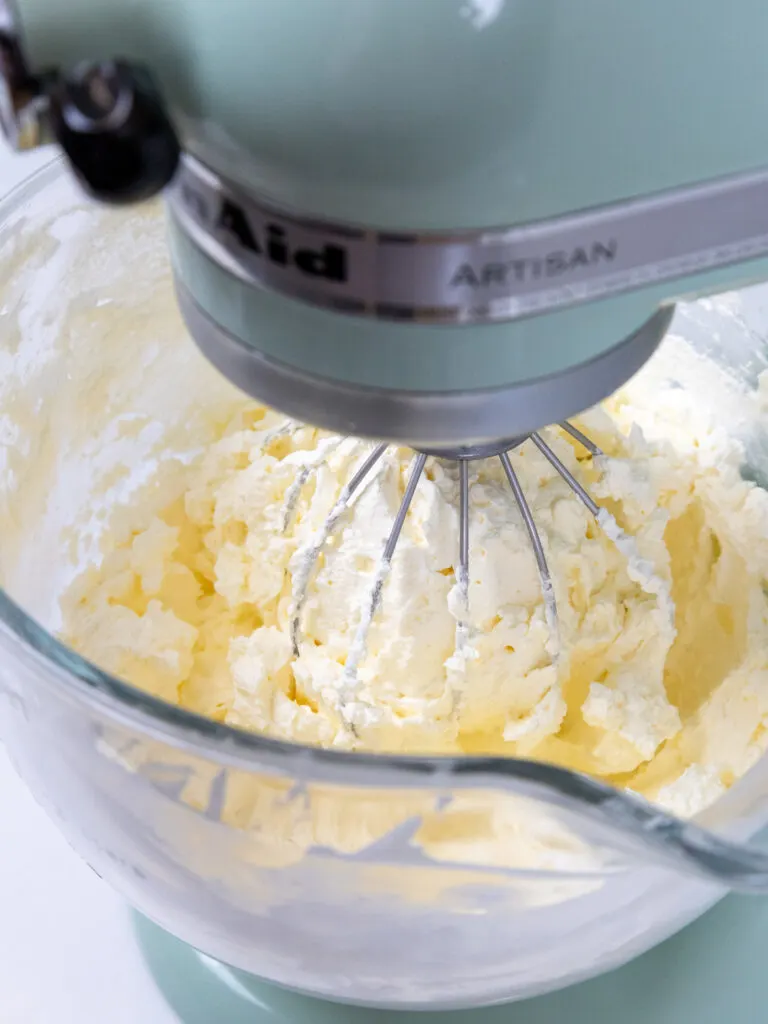 image of fluffy Swiss meringue buttercream that's been whipped up with a whisk attachment and stand mixer