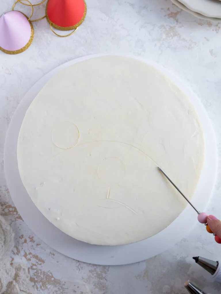 image of the outline of a westie's face being traced onto a cake with a scribe