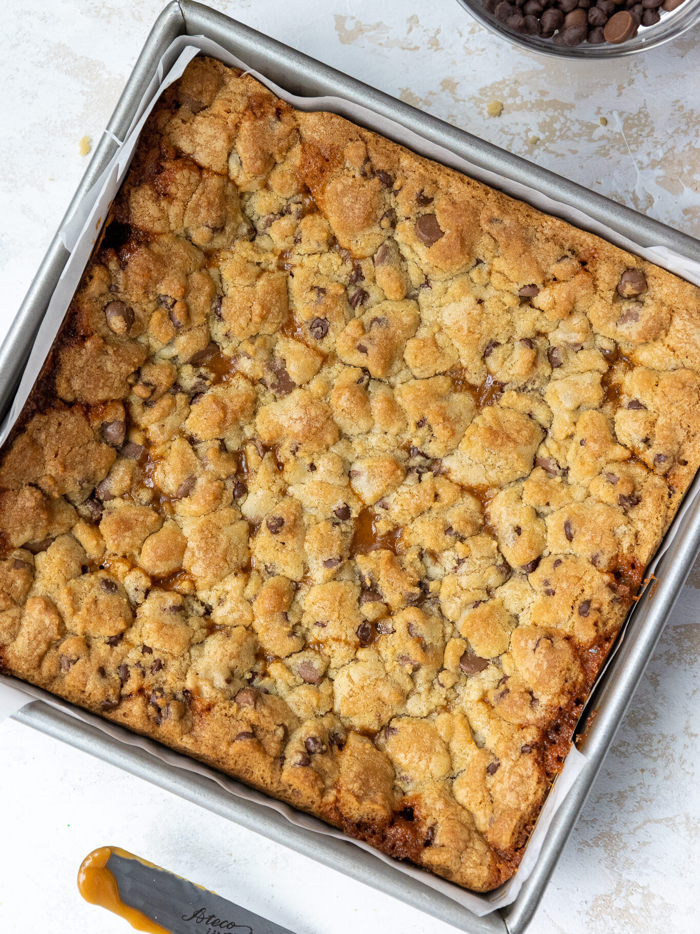 image of baked caramel cookie bars cooling in a pan