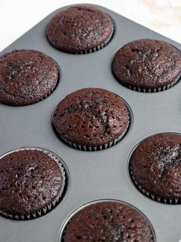 image of baked dark chocolate cupcakes that are cooling in the pan