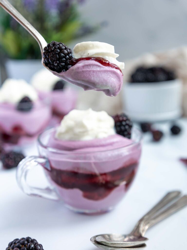 image of a bite of blackberry mousse on a spoon