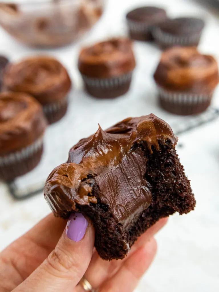 image of a death by chocolate cupcake that's been bitten into to show it's decadent chocolate ganache filling