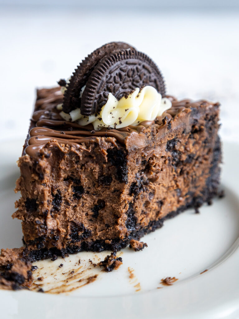 image of a slice of Nutella Oreo cheesecake that's been cut into with a fork