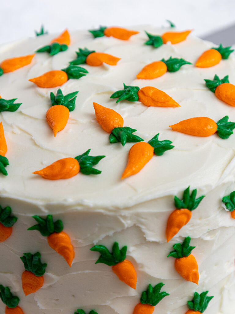 image of a cute carrot cake that's been decorated with little frosting carrots
