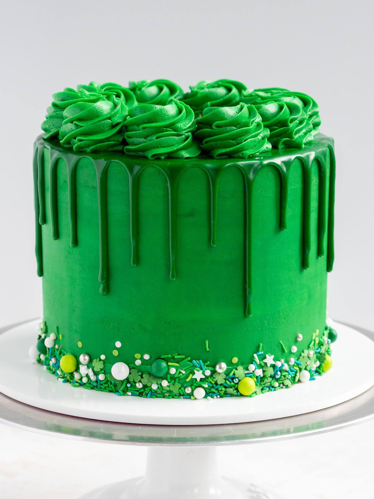 image of an adorable green drip cake that's been decorated to celebrate st. patrick's day