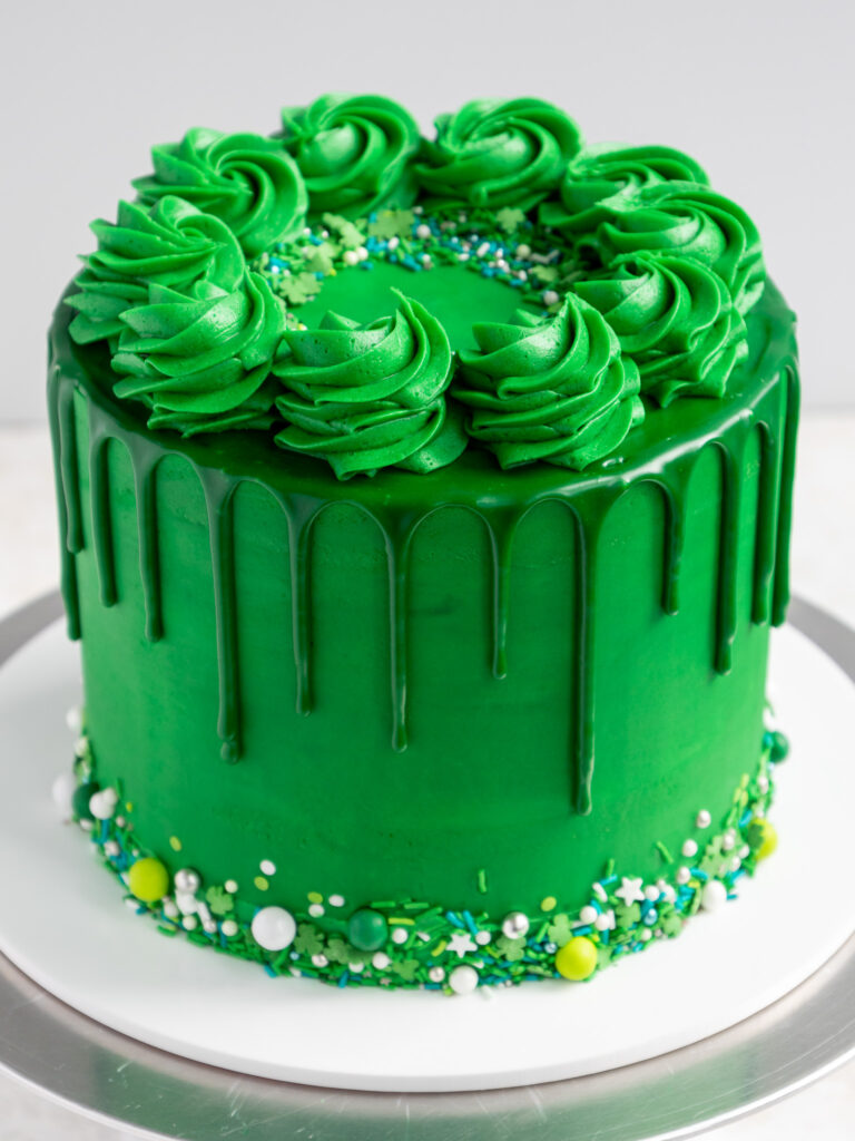 image of an adorable green drip cake that's been decorated to celebrate st. patrick's day