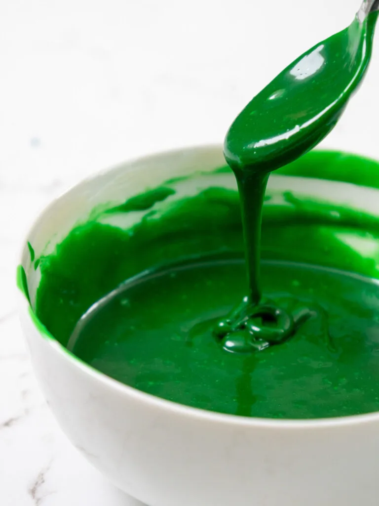 image of green white chocolate ganache being made to add green drips to a cake