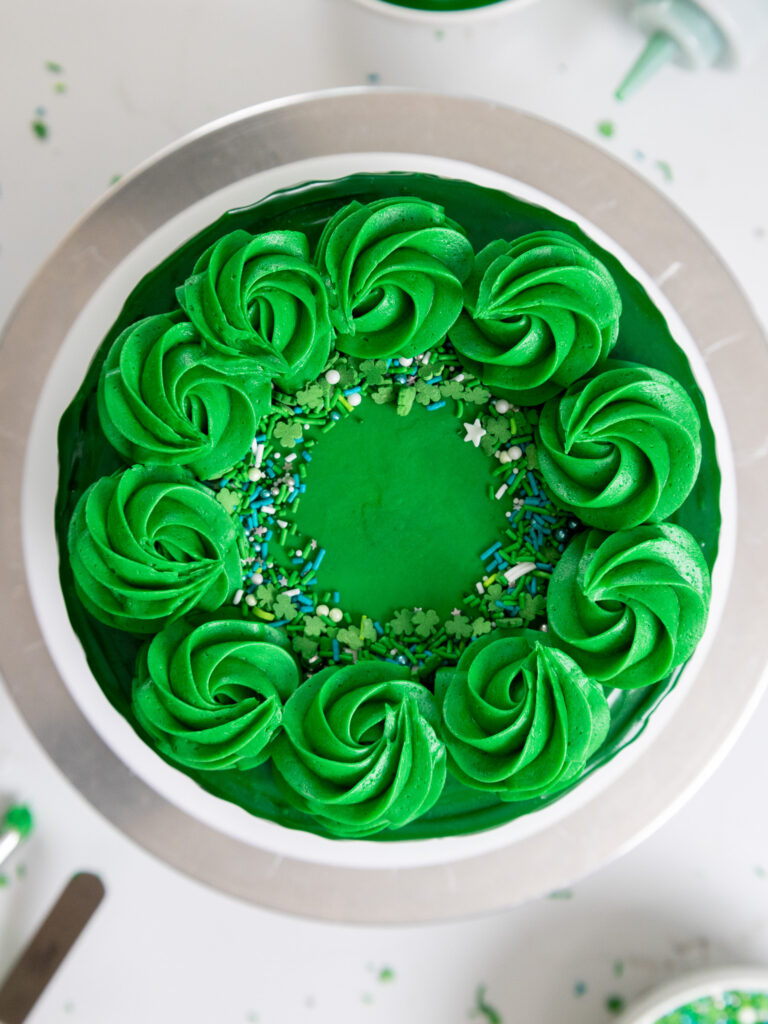 image of a green drip cake from overhead, showing its pretty buttercream swirls