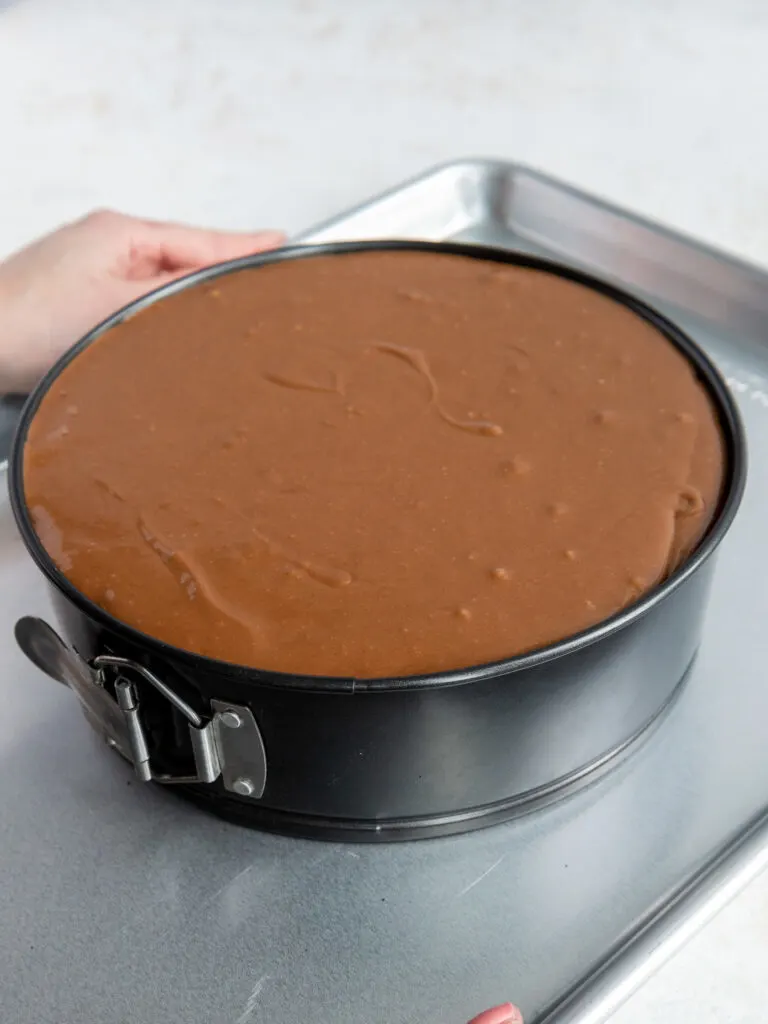 image of chocolate oreo cheesecake on a baking pan that's ready to be baked