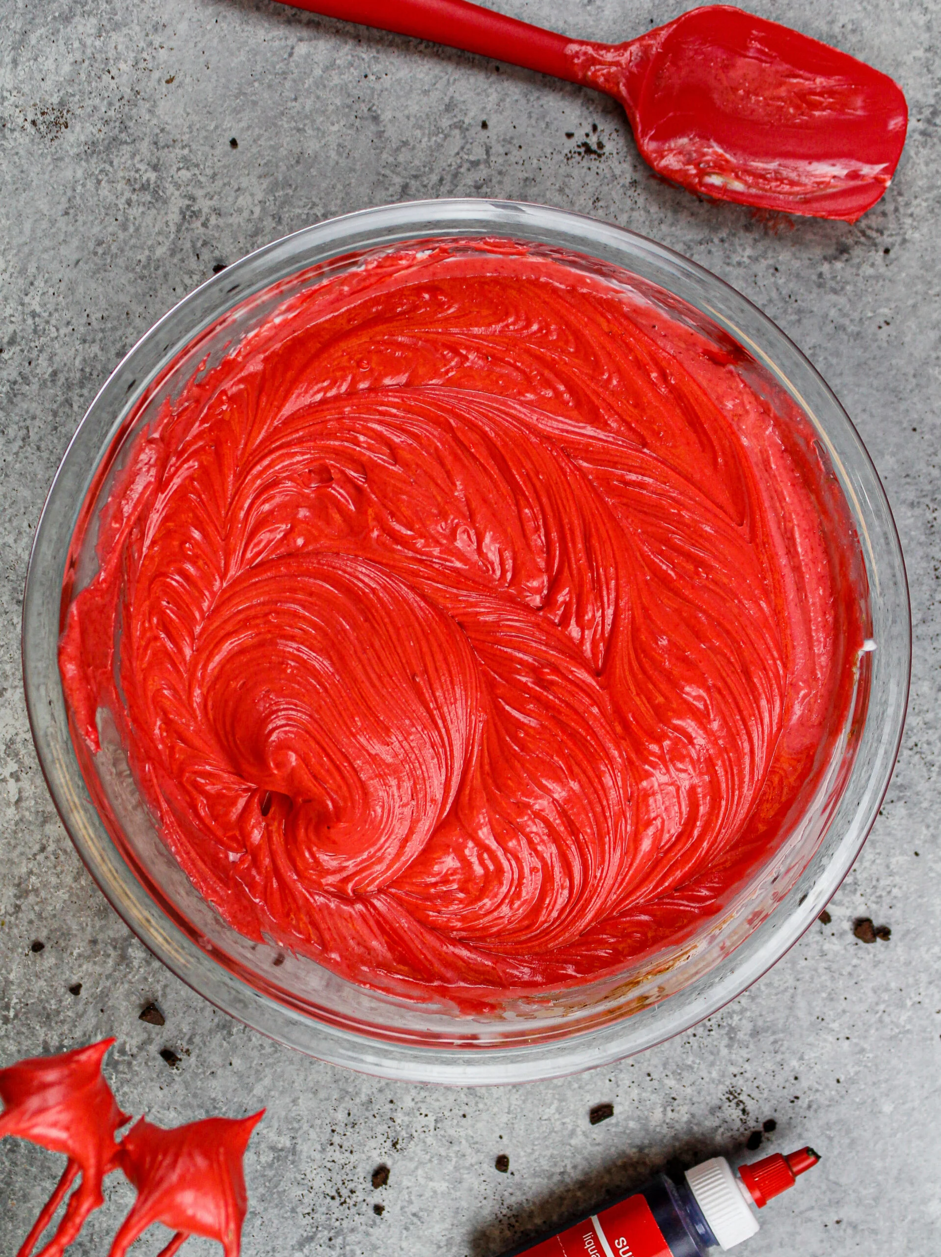 image of red velvet oreo cheesecake batter ready to be poured over its oreo crust and baked