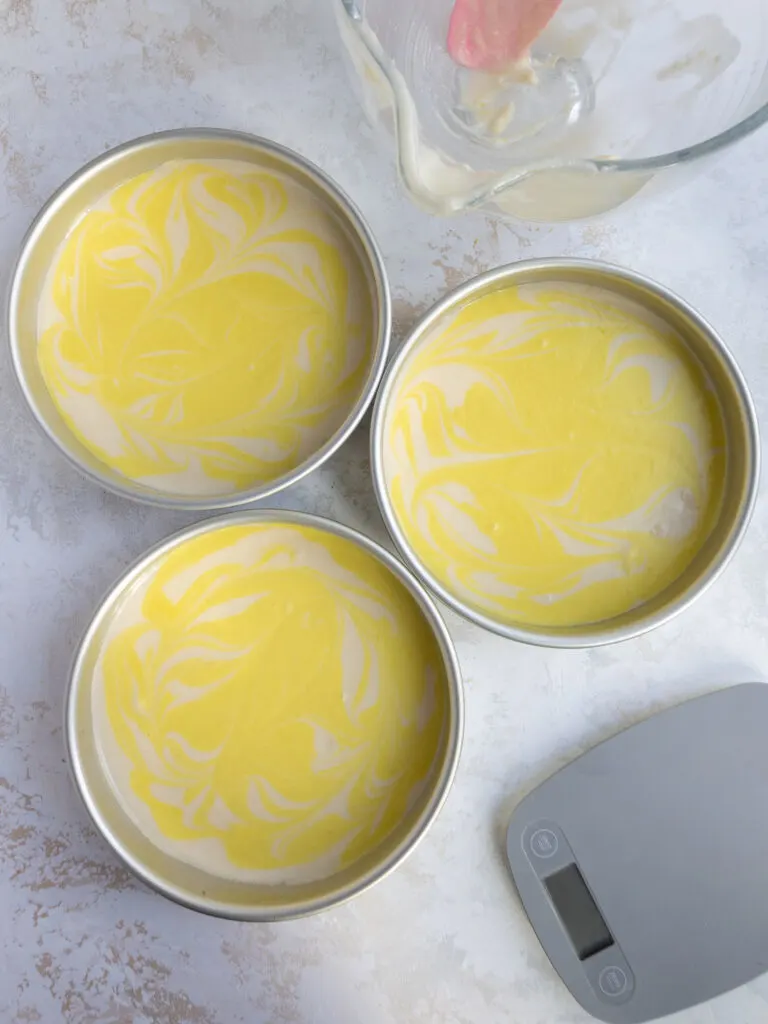 image of lemon cake batter that's been poured into pans and is ready to be baked