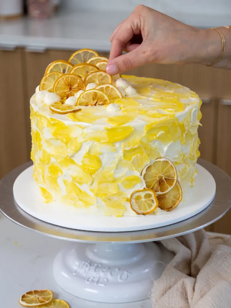 image of a cute lemon curd cake that's been decorated with dried lemon slices