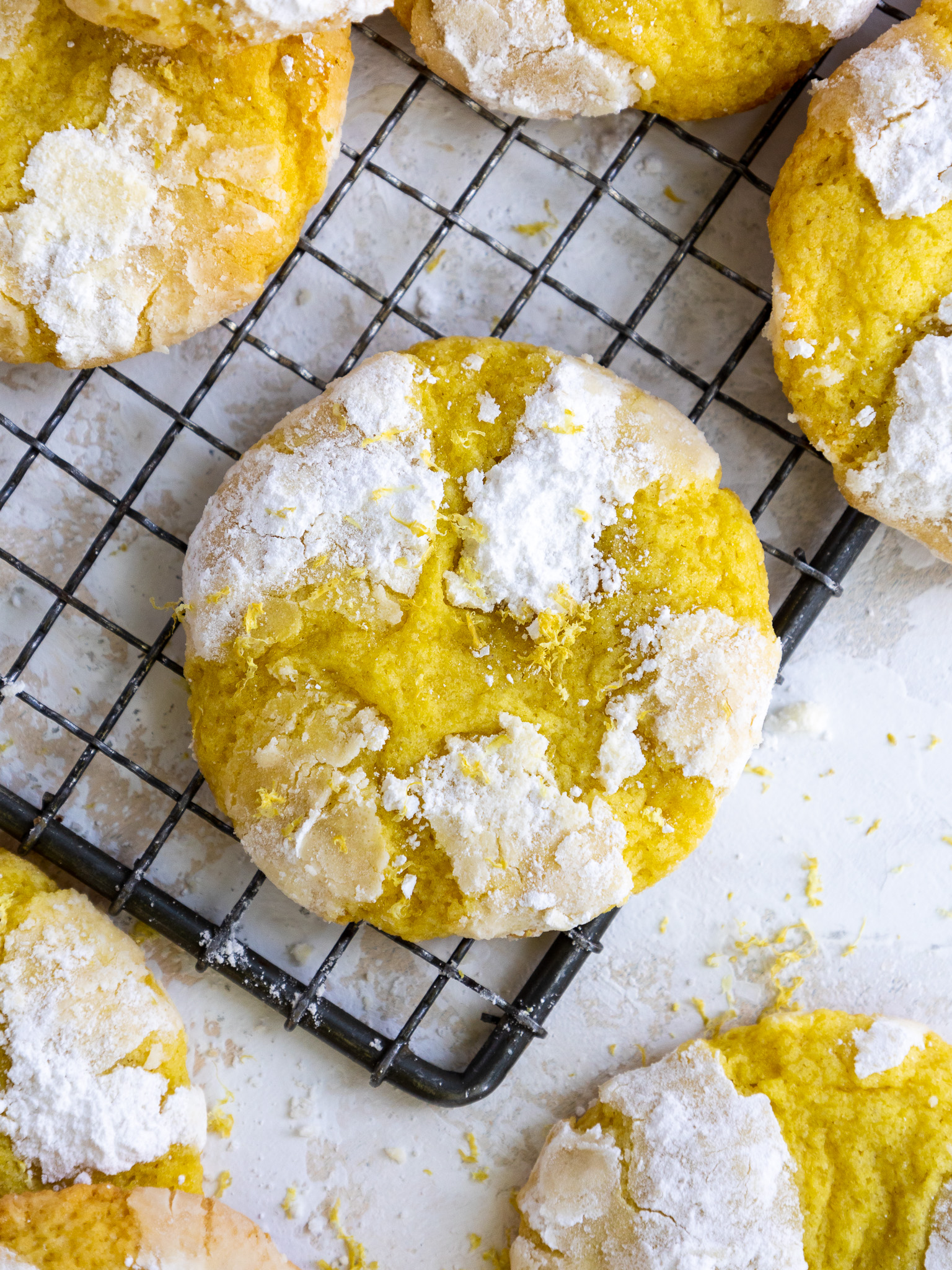 image of lemon crinkle cookies laid out to cool on a wire rack