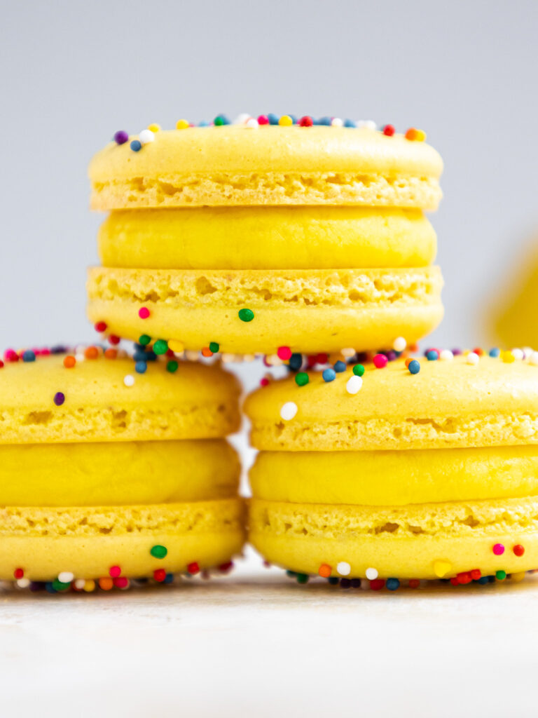 image of lemon macarons that have been filled with lemon white chocolate ganache