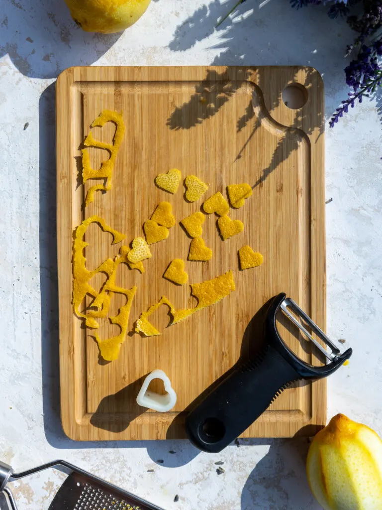image of hearts being cut from lemon peels to make a garnish for lemon lavender cupcakes