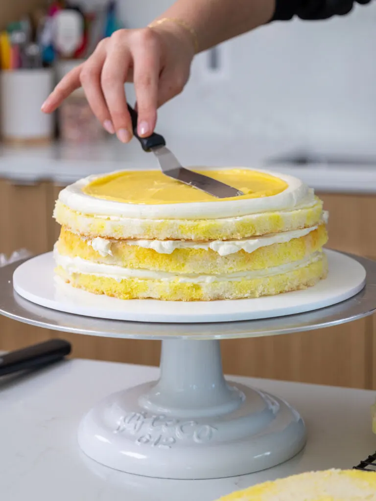 image of a lemon cake being filled with homemade lemon curd