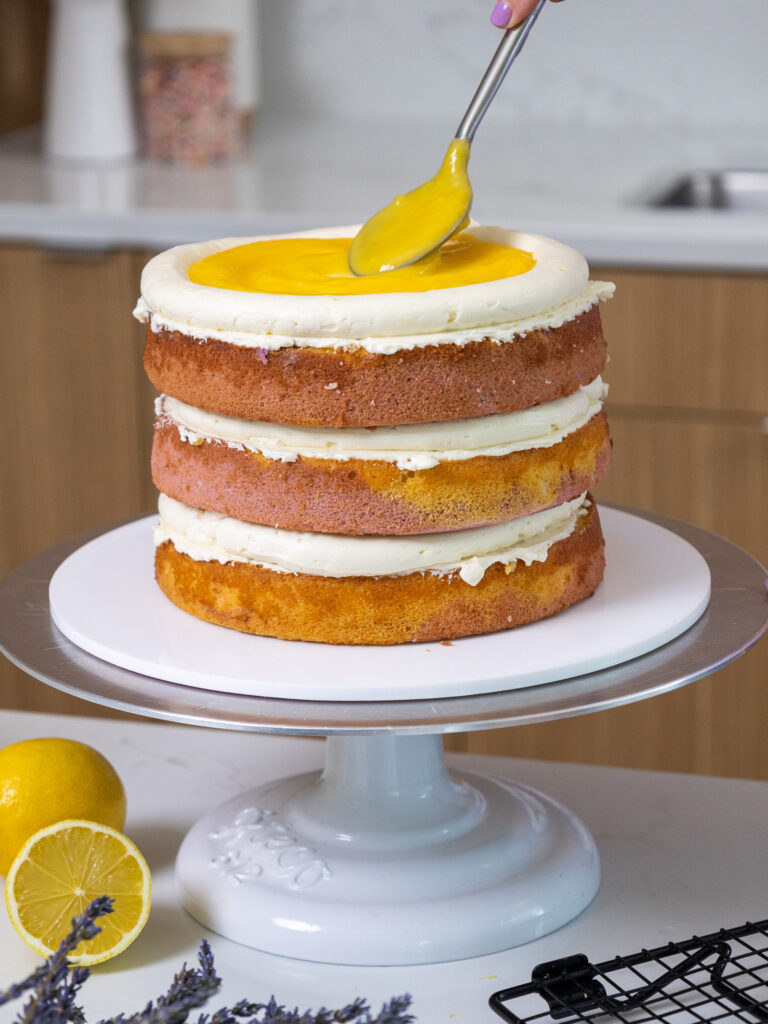image of a lemon lavender cake being filled with lemon curd