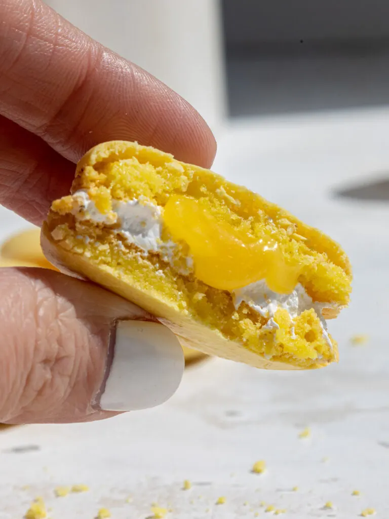 image of lemon meringue macarons filled with Swiss meringue and lemon curd