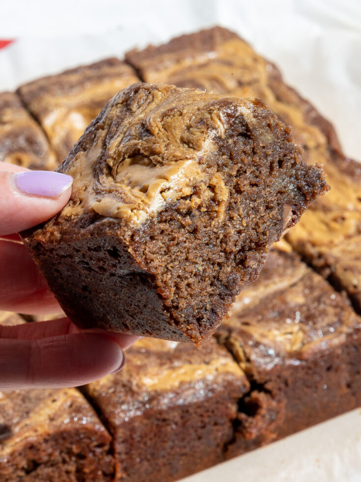 image of a fudgy banana peanut butter brownie that's had peanut butter swirled into the top of it