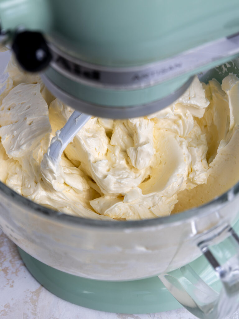 image of lemon swiss meringue buttercream in a kitchenaid mixing bowl
