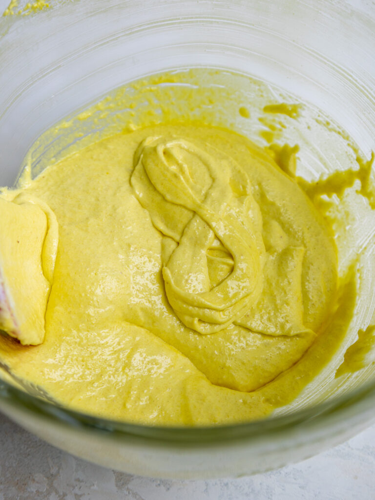 image of light yellow macaron batter that's been mixed the right amount and passes the figure 8 test