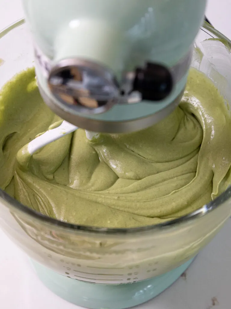 image of matcha cake batter being mixed together in a KitchenAid