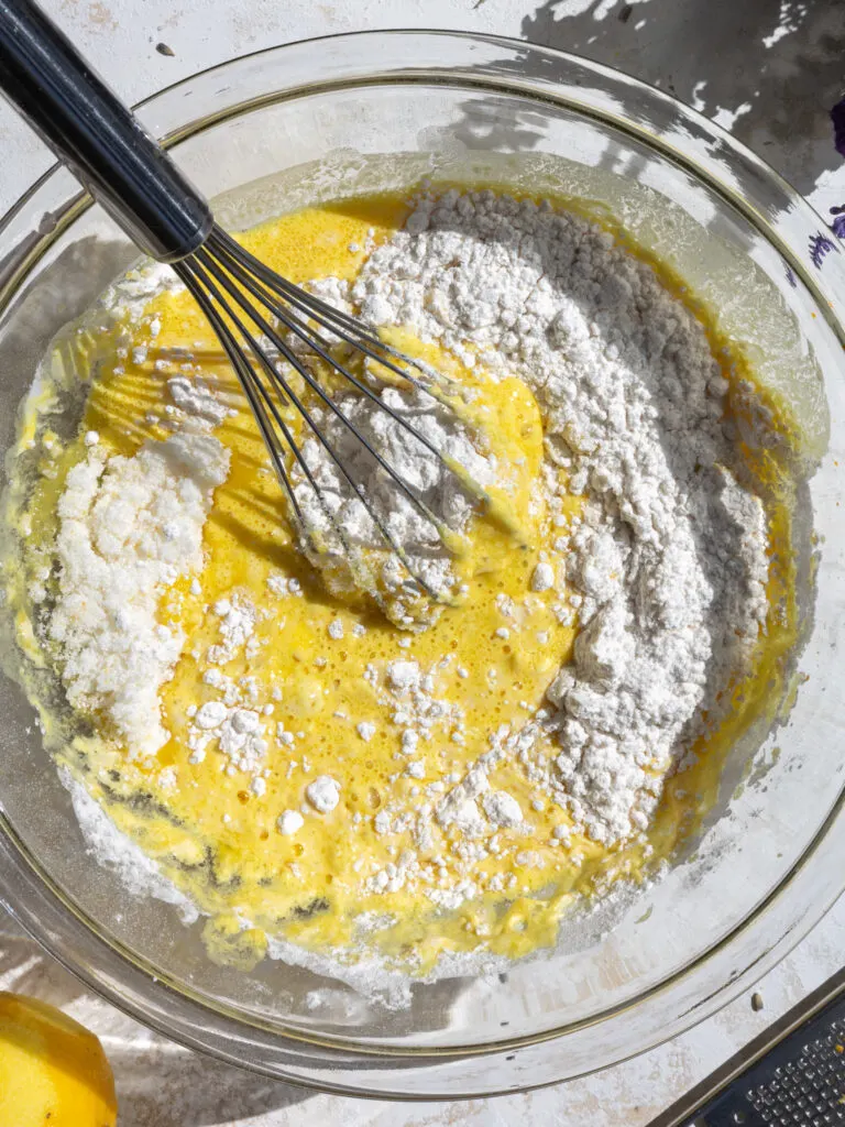 image of lemon cupcake batter being whisked together in a glass bowl
