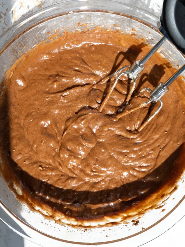 image of peanut butter banana brownie batter being mixed together with a hand mixer