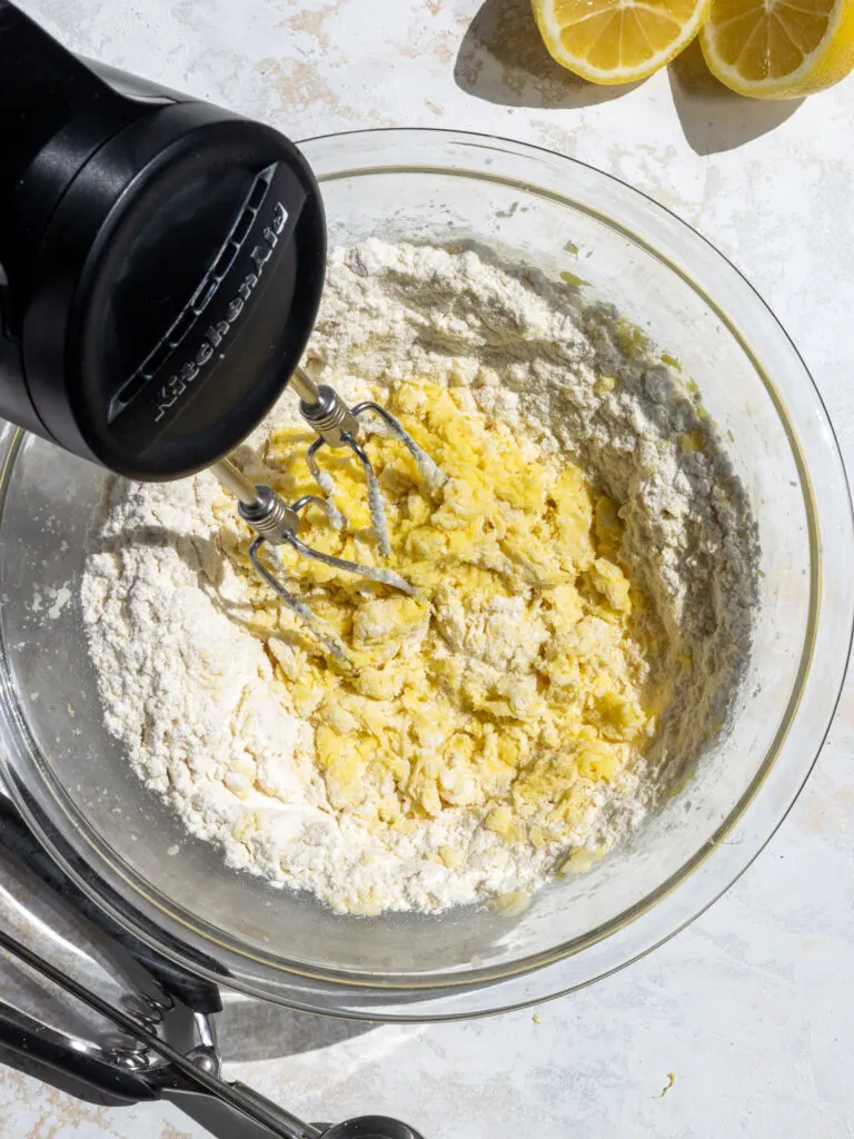 image of gluten free flour being mixed into cookie dough to make gluten free lemon crinkle cookies