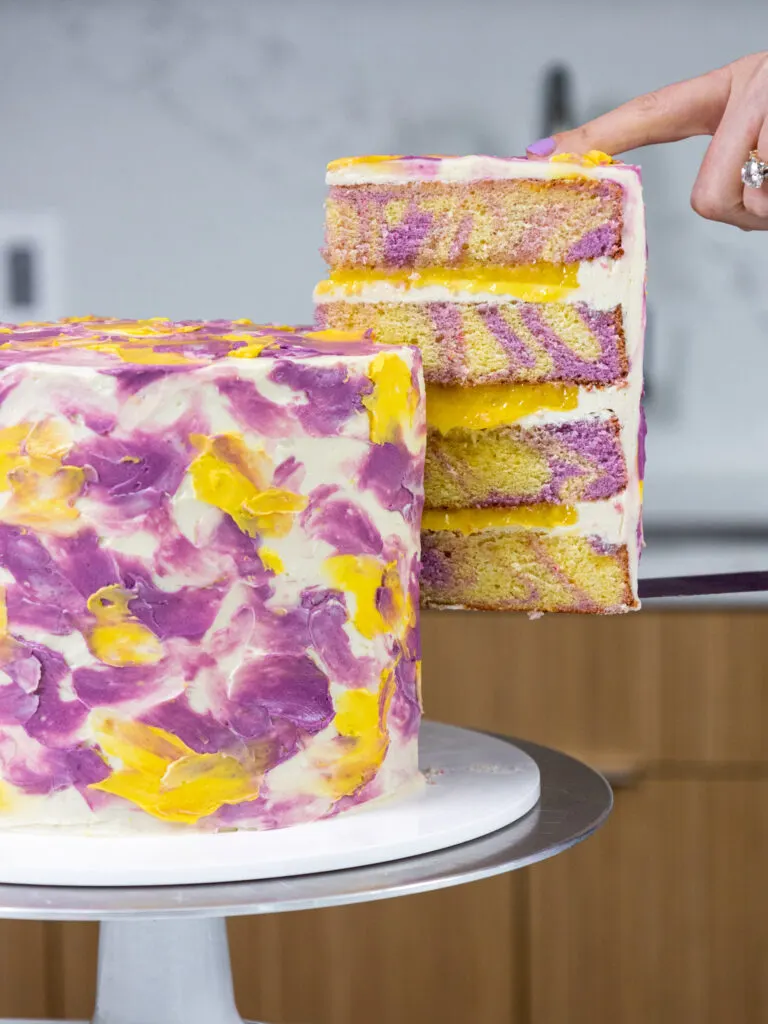 image of a slice of lemon lavender cake being pulled out from a cake